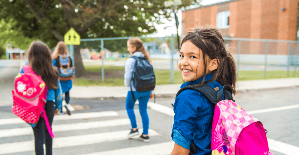 Young students happily walking to school