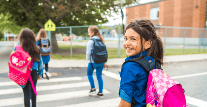 Young students happily walking to school